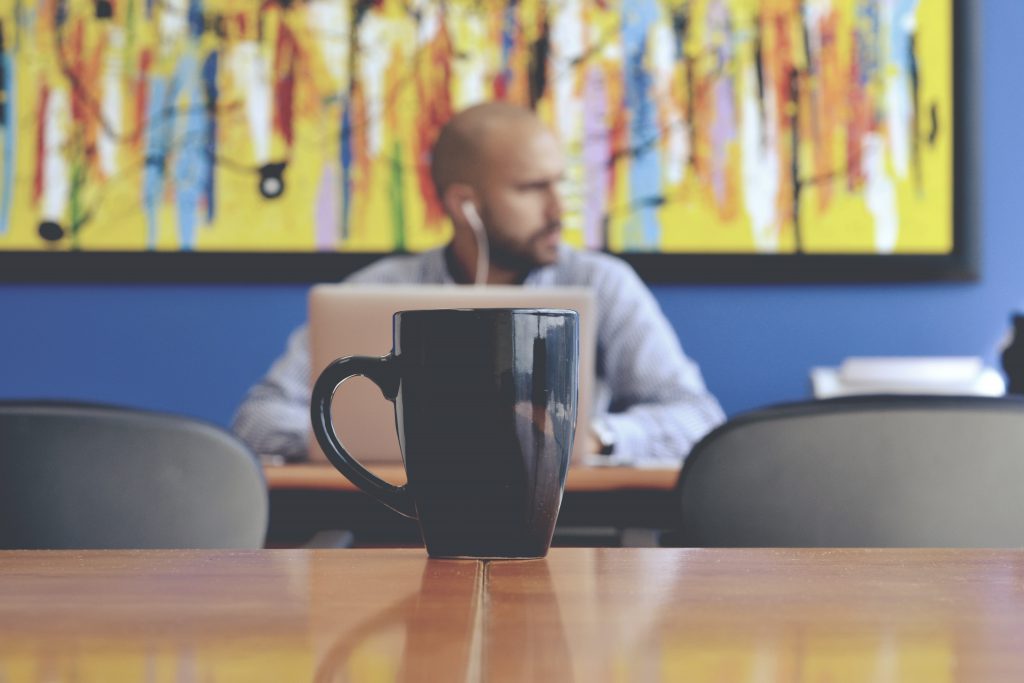 Working man behind a mug